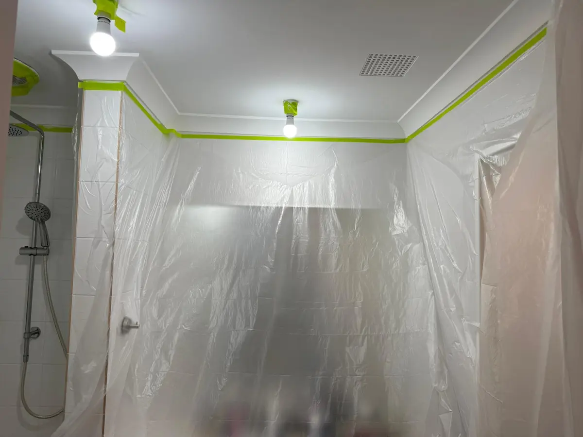 Bathroom masked with plastic sheeting before ceiling painting