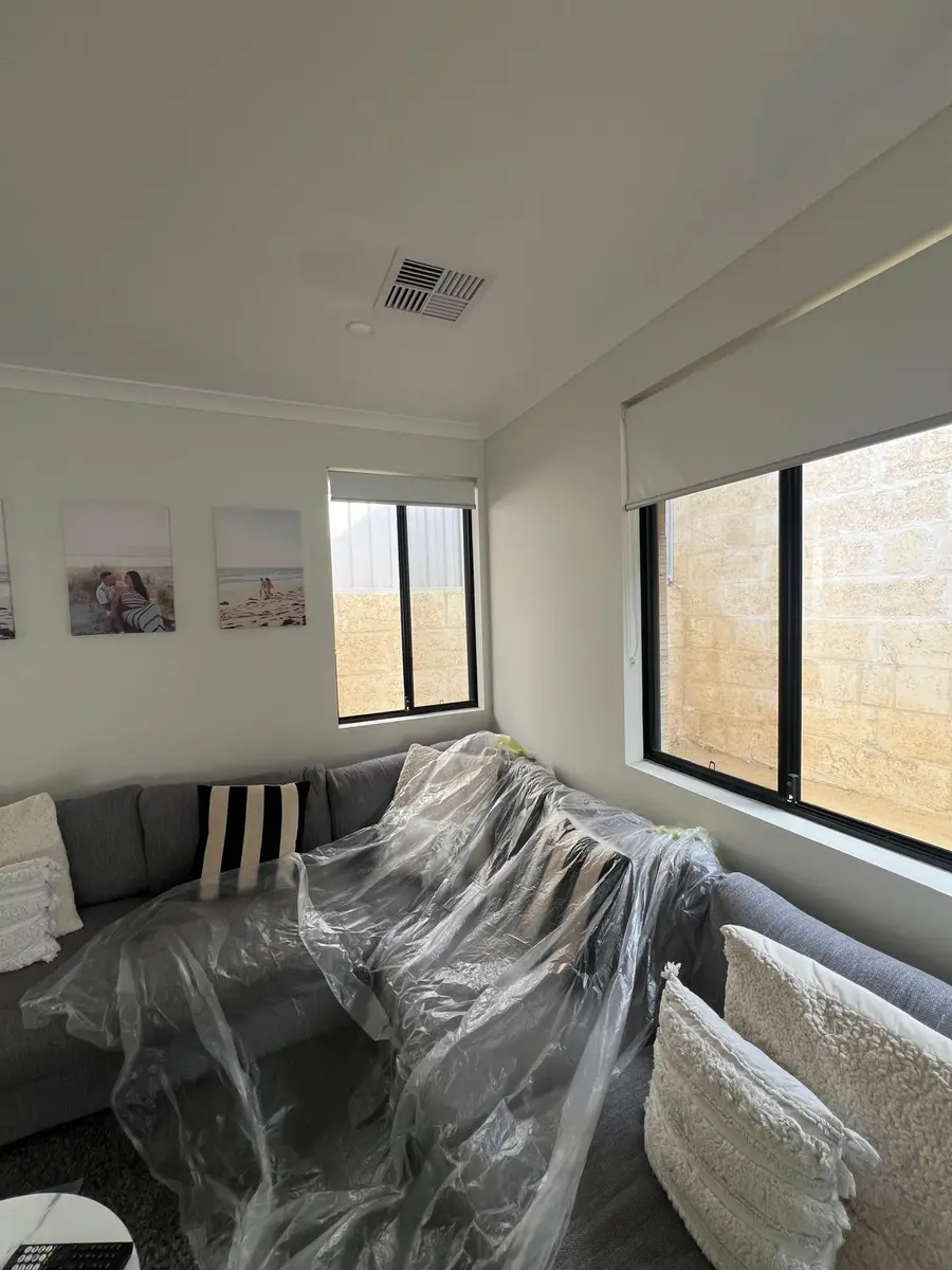 Sofa and furniture covered with plastic before interior painting