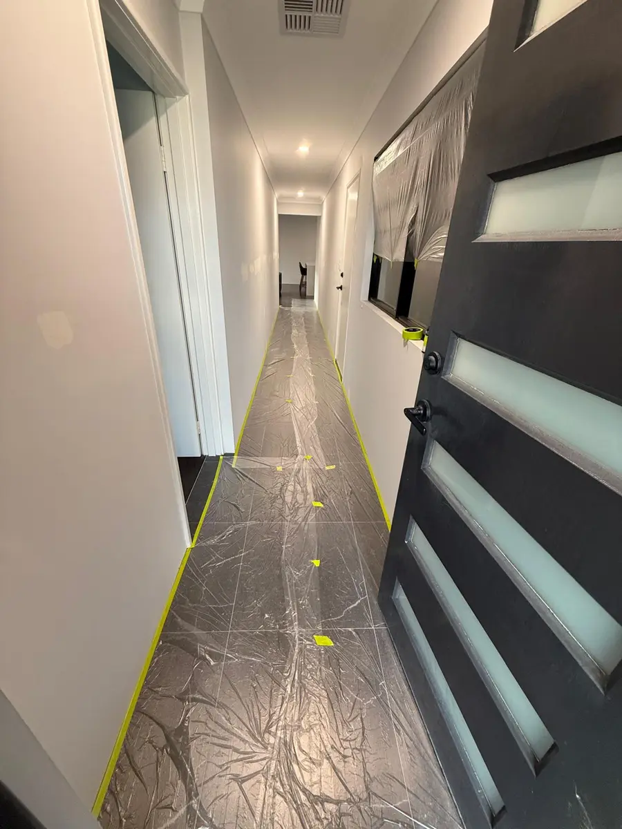 Hallway floors covered and taped before painting