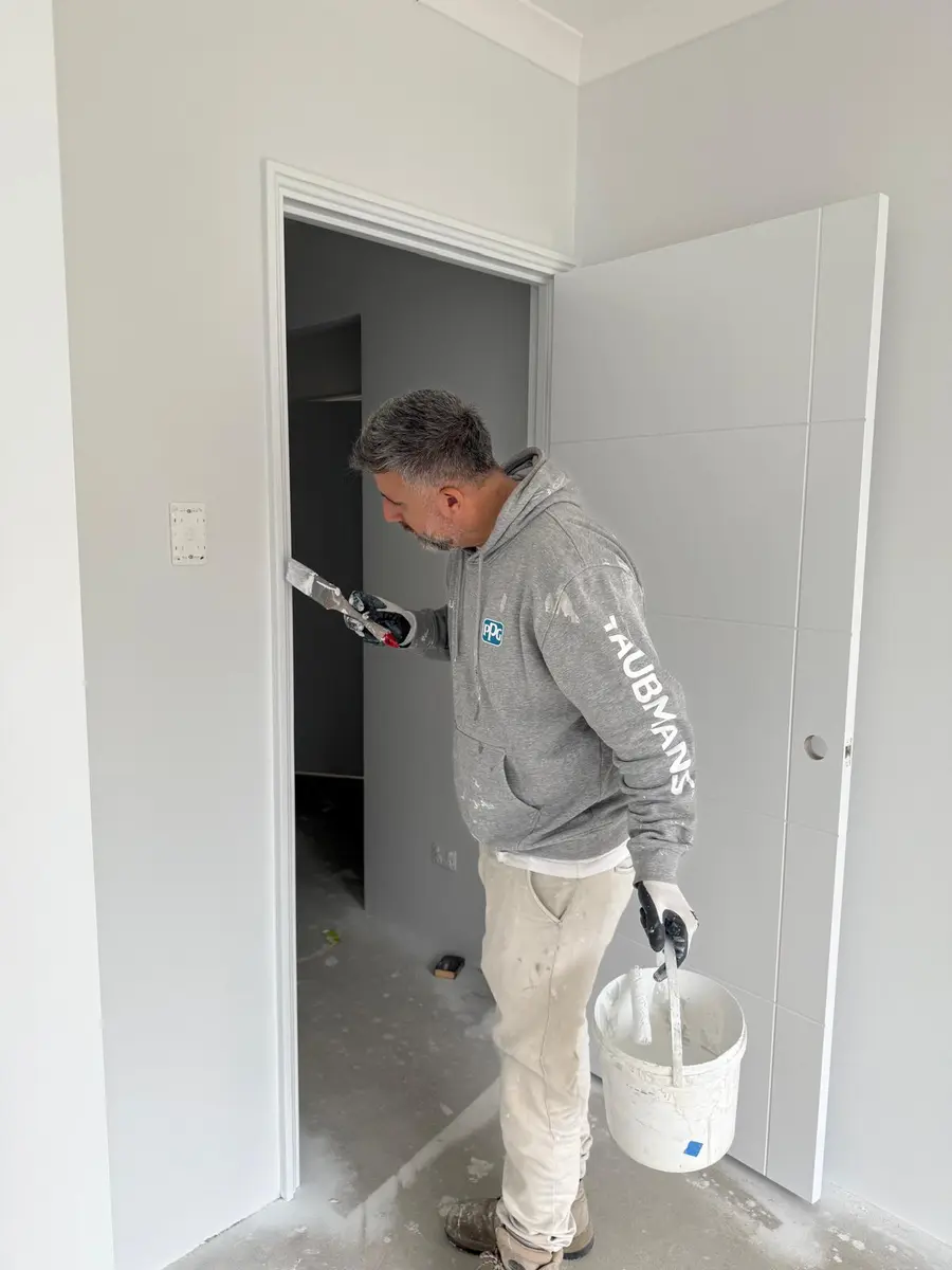 Kevin painting an internal door and frame by brush