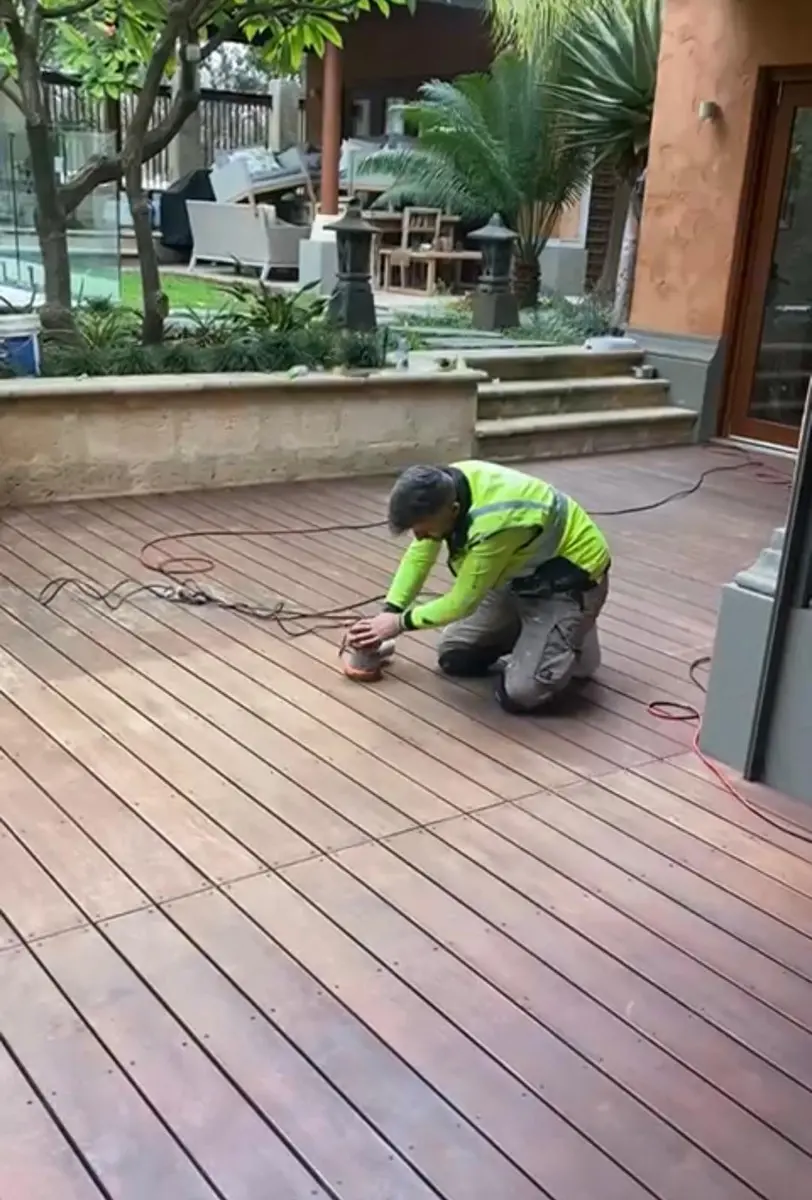 Kevin sanding a timber deck before oiling