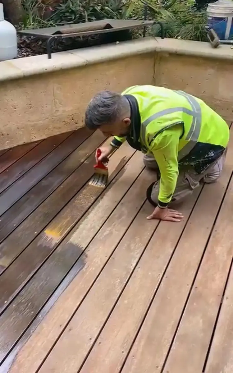 Kevin staining a timber deck by brush