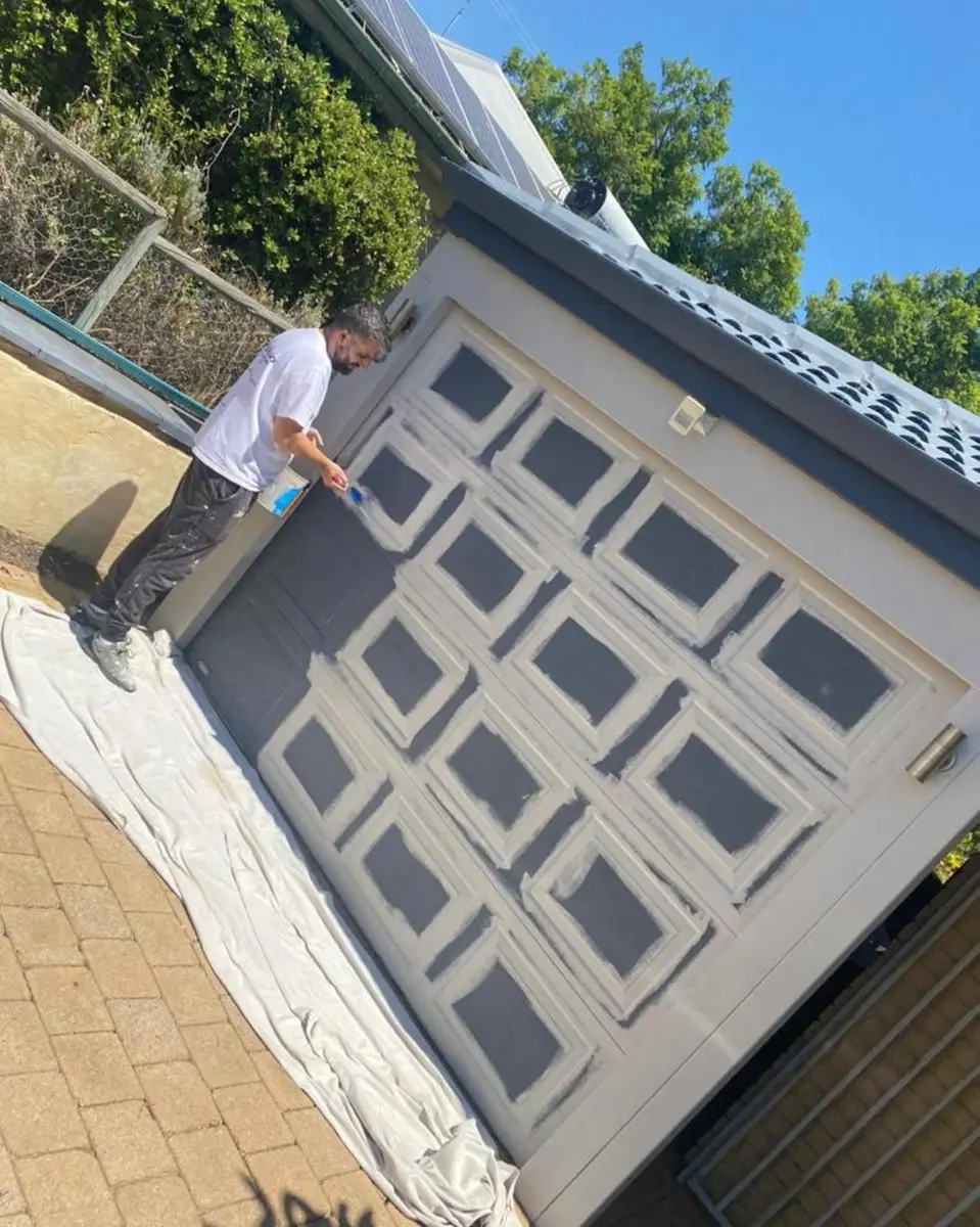 Kevin painting a garage door