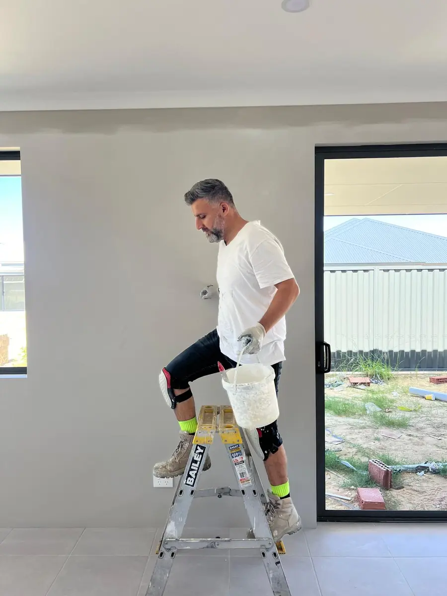 Kevin painting the interior of a new build home